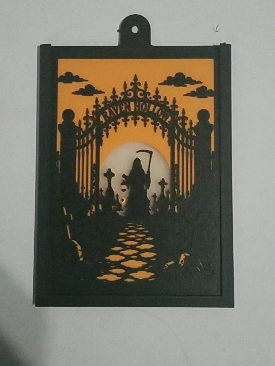 Close view of a Halloween panel fitted in its black window hanger
