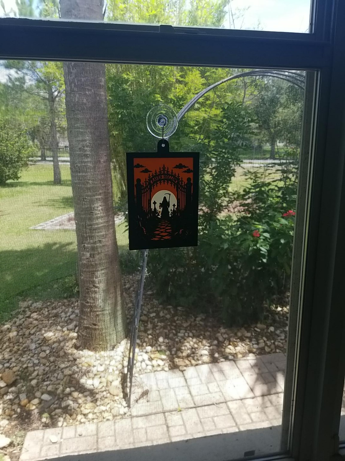 CastleGlow Graveyard Reaper panel hanging in a sunlit window